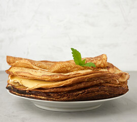 stack of fried round pancakes on a plate