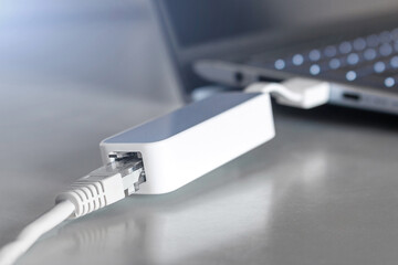 adapter for connecting an internet cable to a laptop closeup. usb - rj45