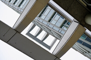 Fototapeta premium Abstract low angle view of a modern architecture building facade with panels creating a black and white structure.