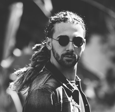 Attractive, Young Blonde Bearded Male Model With Combination Of Braids And Dreadlocks Posing In The Wild. Style, Trends, Fashion Concept