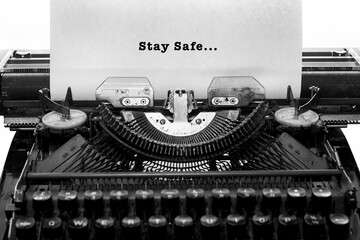 Old vintage typewriter and a sheet of paper inserted with written STAY SAFE.