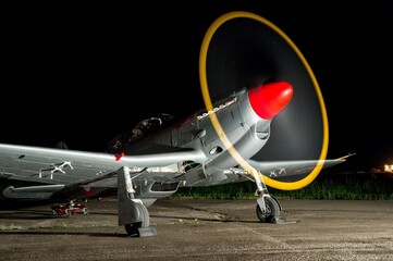 Aircraft with its propeller spinning fast at night