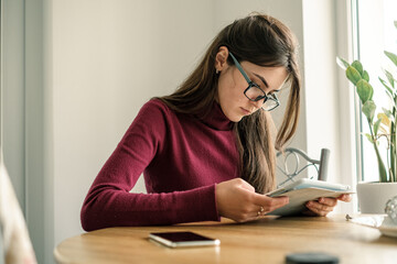 Close up of girl working on tablet from home during period of restrictions.