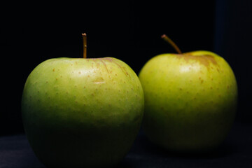 green apples on black background
