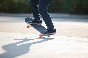 Fototapeta na wymiar Skateboarder skateboarding at morning outdoors