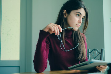 Close up of girl working on tablet from home during period of restrictions.