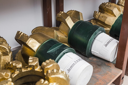 Drill bit on shelving in stock. Oil drilling equipment for drilling rig operation on oil platform in oil and gas industry. Brand new PDC Polycrystalline Diamond Compact drilling head for core drilling