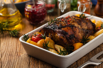 Roasted whole shoulder, with potatoes, peppers and tomatoes. Marinated in white wine.