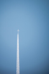 the plane is flying in a clear sky