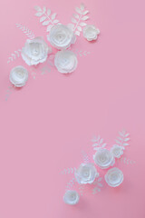 Handmade paper art and cut white flowers on pink background. 