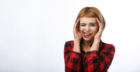 Red haired lady closed one eye and holds hands near face. Young woman Portrait with different happy emotions.