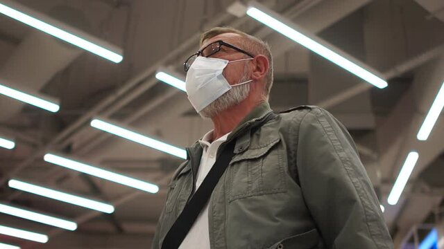 Mature man with a mask and glasses for vision. Social distance concept, close indore portrait