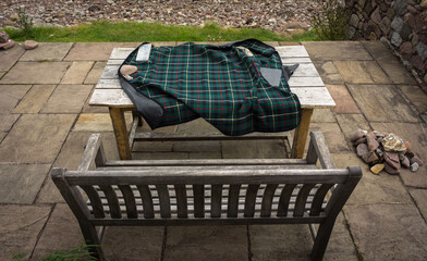 Scottish blanket spread on a wooden bench