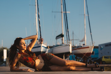 Girl in a beach suit in front of boat