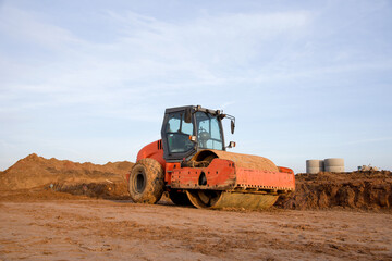Vibration single-cylinder road roller the leveling soil at construction site. Soil Compactor during the construction of roads