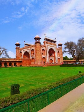 the great gate of Taj Mahal with garden in Agra, India. famous buildings in the world sits is a red sandstone building known as Darwaza-i Rauza. it is a main entrance gate of Taj Mahal.