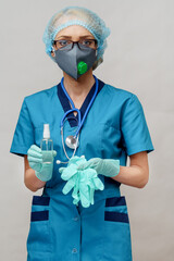 medical doctor nurse wearing protective mask - holding bottle of sanitizing spray or gel