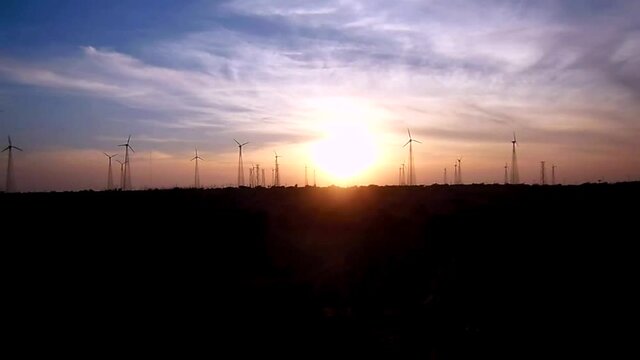 Sunset behind the Windmills, a view from Bara bagh Jaisalmer, Rajasthan India
