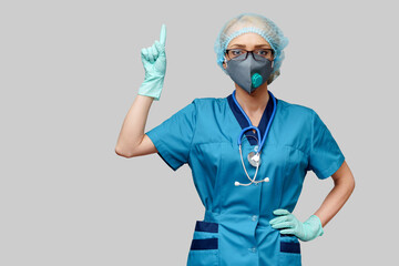 female doctor with stethoscope wearing protective mask and latex gloves over light grey background