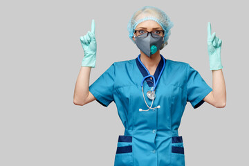 female doctor with stethoscope wearing protective mask and latex gloves over light grey background