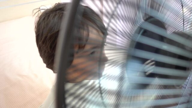 4K Coronavirus home video - Child enjoys blow in front of of ventilator
