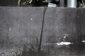a plastic cup has overturned spilling its contents on the wall creating an abstract stain