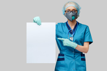 female doctor with stethoscope wearing protective mask and latex gloves holding blank sign over...