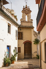 Fototapeta na wymiar old street in the city of Cordoba with a small church