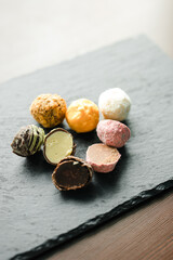 colored candy truffle on a black plate