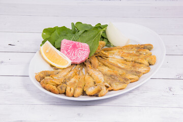 sea food plate with fried fish, lemon and onion