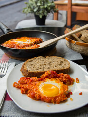 Shakshouka - dish of eggs fried with tomatoes onions and fried egg