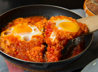 Shakshouka - eggs in tomato sauce, served in a frying pan