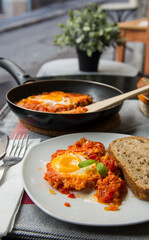 Shakshouka - dish of eggs fried with tomatoes onions and fried egg