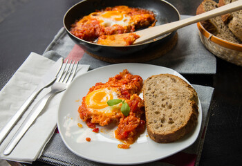 Shakshouka - dish of eggs fried with tomatoes onions and fried egg