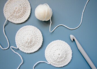 crochet hook with white wool and hand made crocheted circles 