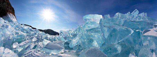 Siberian Baikal Lake in the winter. Panoramic view of ice hummocks near Cape Khoboy of Olkhon Island on a sunny frosty day. Winter travel. Natural background. Unusual landscape