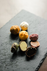 colored candy truffle on a black plate