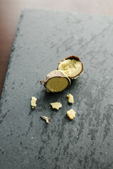 truffle candies on a black plate with green and pink filling