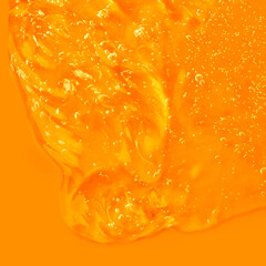 Cream gel cosmetic lubricant . Transparent smudge yellow orange. The texture of gel cream. A sample of a cosmetic product.