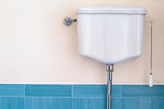 retro white toilet tank hung on the wall in the bathroom.