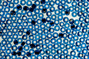 Abstract image consisting of scattered beads. Blue tones.