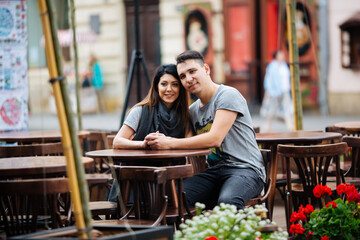 A couple in love slowly walks the streets of the city on a cool autumn morning.