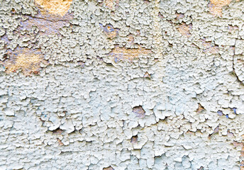 Old peeling paint on a vintage stucco wall. Cracked vintage paint in red, green and blue.