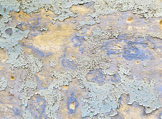 Old peeling paint on a vintage stucco wall. Cracked vintage paint in red, green and blue.