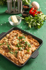 Tasty beef stroganoff on color background