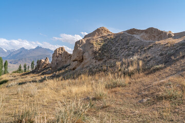 The view of old ancient ruined city Koshoy Korgon and the clay city wall in Kyrgyzstan