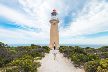 Fototapeta na wymiar Woman walking towards Cape Du Couedic Lighthouse, Kangaroo Island