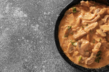 Tasty beef stroganoff on grey background