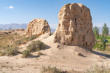 The view of old ancient ruined city Koshoy Korgon and the clay city wall in Kyrgyzstan