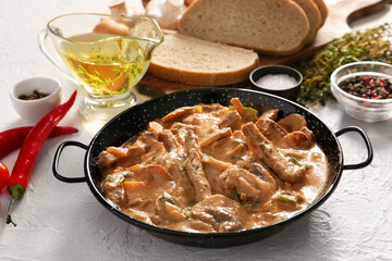 Tasty beef stroganoff with products on white background